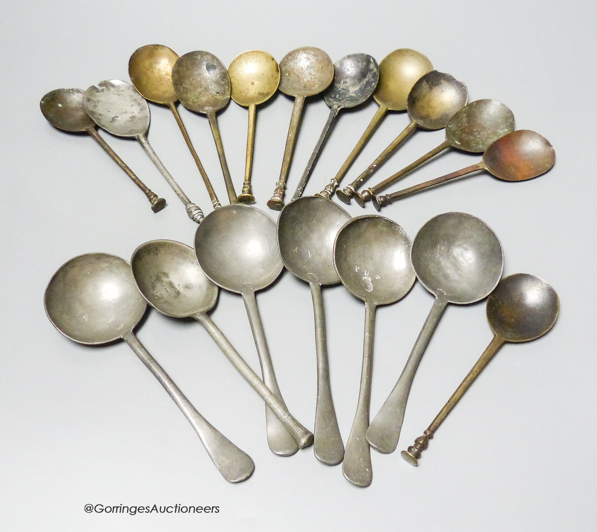 A collection of twenty four 16th to 18th century brass and pewter spoons (faults)